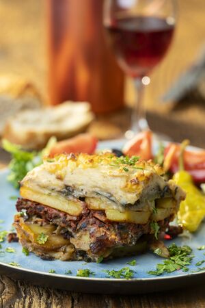 portion of greek moussaka on woodの写真素材