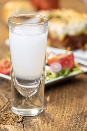 greek ouzo with moussaka on woodの写真素材