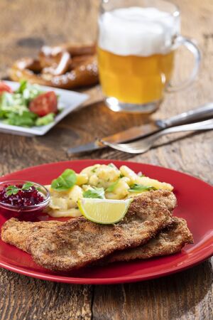 wiener schnitzel with potato salad on a plateの写真素材