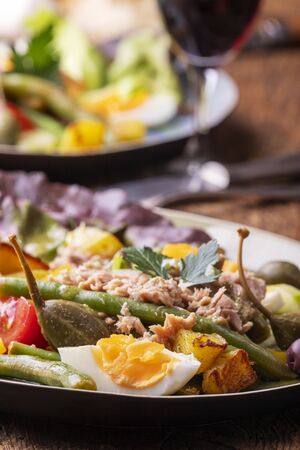 closeup of salade nicoise on dark woodの写真素材