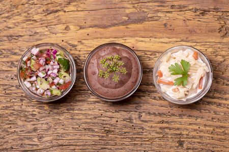 three mexican salsas on dark wood の写真素材
