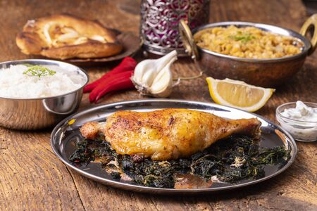 indian spinach chicken on dark woodの写真素材