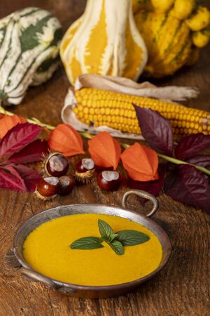 pumpkin soup on dark woodの写真素材