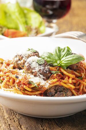 spaghetti with meat balls on dark wood の写真素材