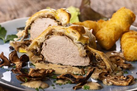 pork filet in puff pastry with croquettesの写真素材