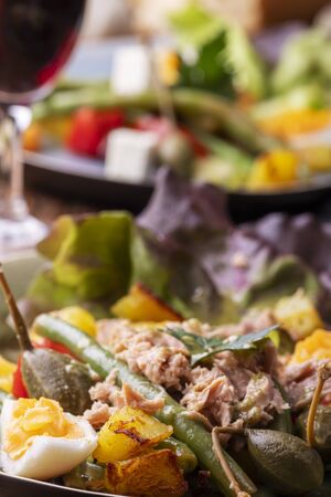 closeup of salade nicoise on dark woodの写真素材
