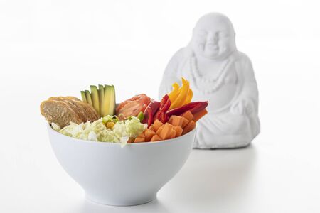 buddha bowl with chicken on white の写真素材