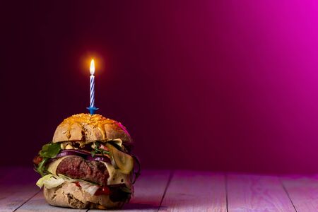 home made cheeseburger on dark wood の写真素材