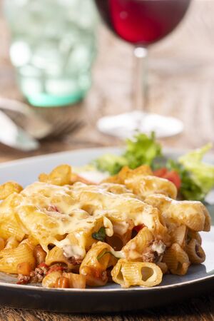 portion of a pasta gratin on woodの写真素材