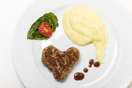 heart shaped meat loaf on a plate の写真素材