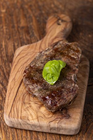 overview of a grilled steak on wood の写真素材