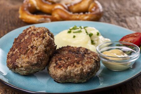 two bavarian meat loafs on a plate の写真素材