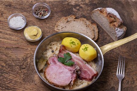 closeup of a french choucroute dish on wood の写真素材