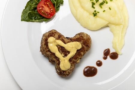 heart shaped meat loaf on a plate の写真素材