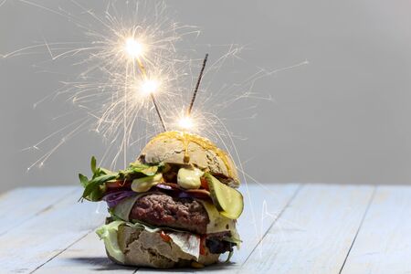 home made cheeseburger on dark woodの写真素材