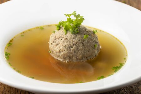 bavarian liver dumpling soup on wood の写真素材