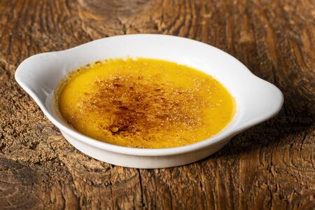 creme brulee on dark woodの写真素材