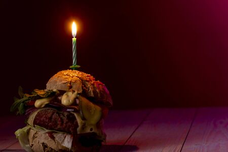 home made cheeseburger on dark woodの写真素材