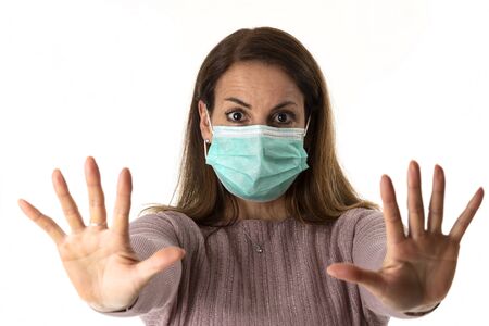 scared woman with a mask on whiteの写真素材