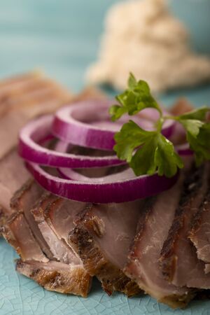 slices of cold roast pork with onionsの写真素材