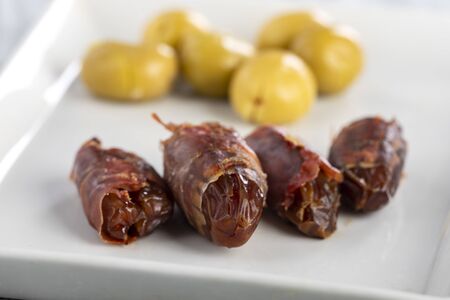 spanish dates with ham on a plateの写真素材