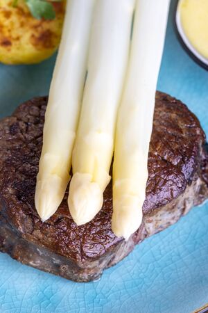 asparagus with potatoes and a steakの写真素材