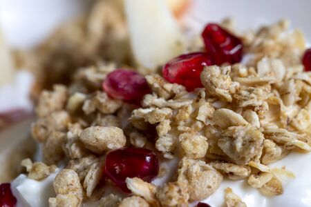 closeup of a muesli on yoghurt with pomegranateの写真素材
