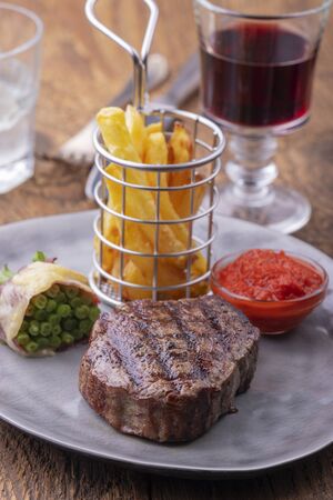 closeup of grilled steak with french friesの写真素材
