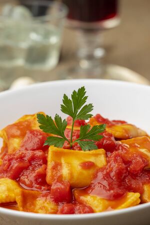 ravioli with tomato sauce on a plateの写真素材