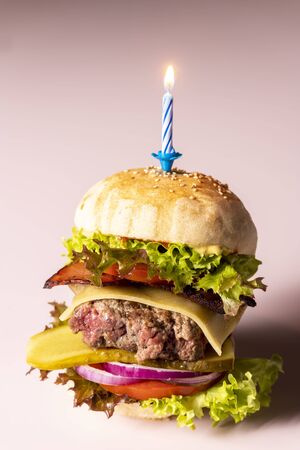 closeup of a single cheeseburgerの写真素材