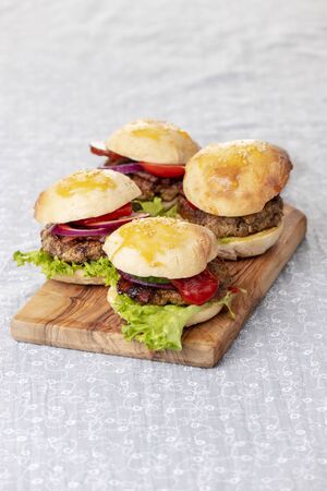 four small hamburges on a boardの写真素材