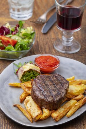 closeup of grilled steak with french friesの写真素材