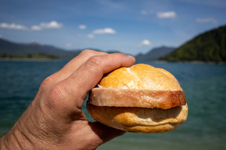 hand holding a meat loaf bun at Walchensee