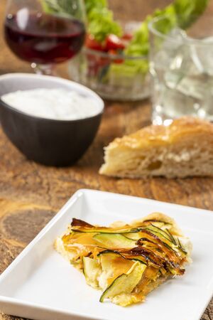 shortcrust pie with carrots and zucchini on woodの写真素材