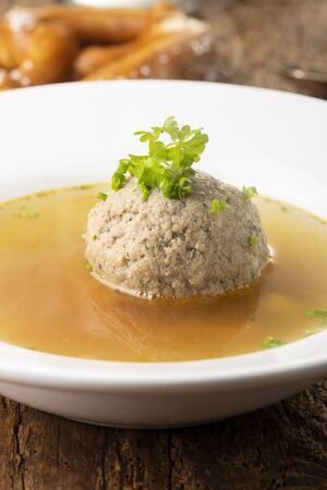 bavarian liver dumpling soup on woodの写真素材