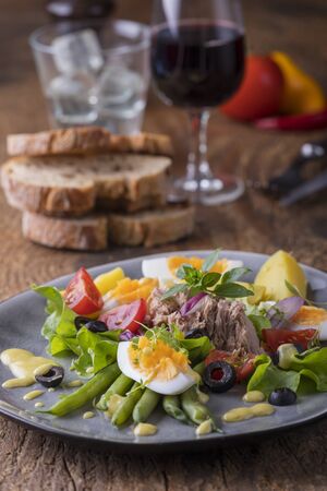 salad nicoise on a wooden backgroundの写真素材