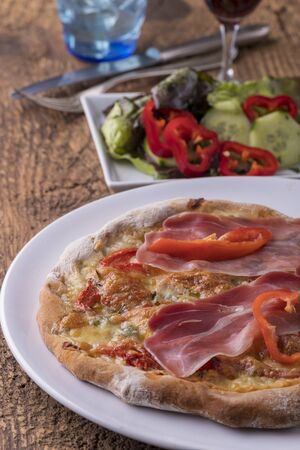 detail of a pizza with ham and basilの写真素材