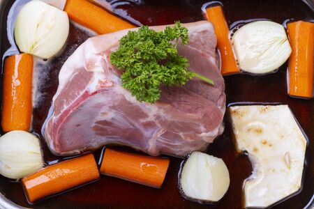 raw pork meat on beer sauceの写真素材