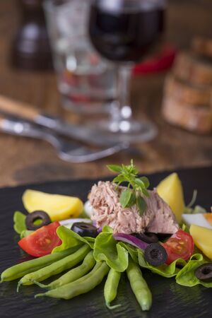 salad nicoise on a wooden backgroundの写真素材