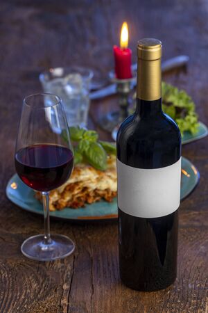 red wine and lasagna on woodの写真素材