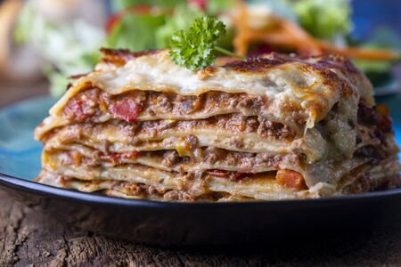 portion of fresh lasagna on a plateの写真素材