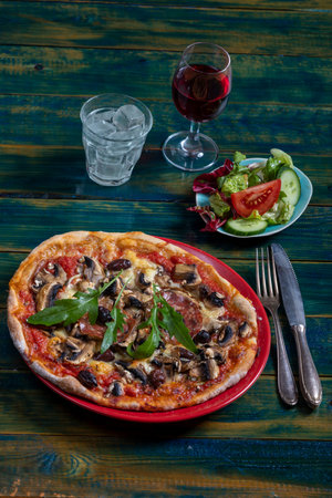 overview of a pizza with saladの写真素材