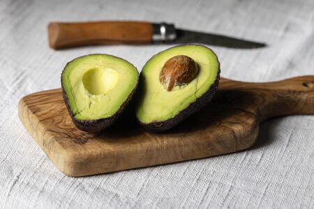 halves of avocado on a boardの写真素材