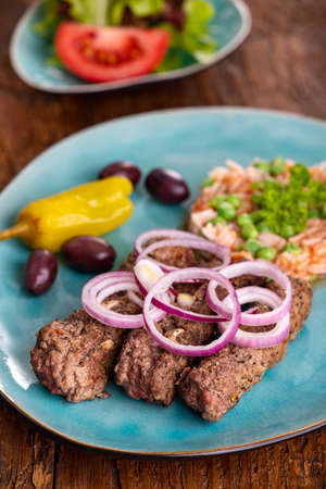 cevapcici with djuvec rice on woodの写真素材