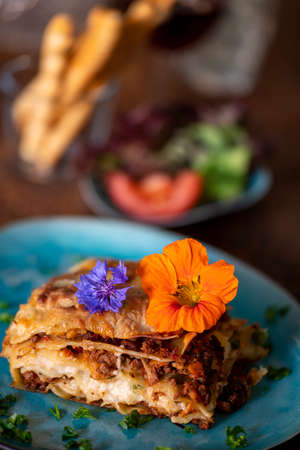 fresh lasagna on a blue plateの写真素材