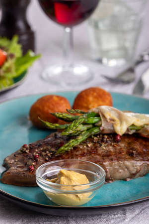 green asparagus on a steakの写真素材