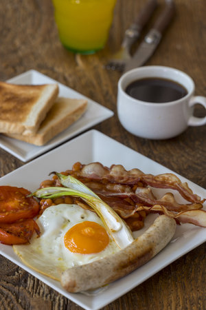 english breakfast on wood with coffeeの写真素材