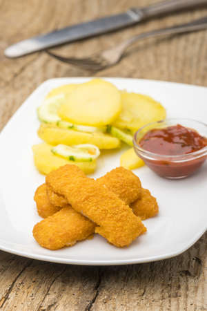 fish fingers with potato saladの写真素材
