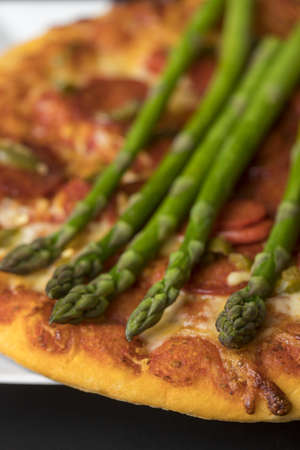 closeup of an pizza with asparagusの写真素材