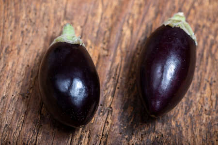two small eggplants on woodの写真素材